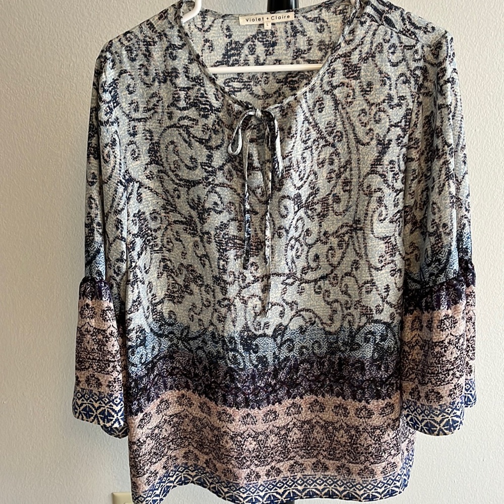 Blouse with 3/4 length bell sleeves, tie at the neck line, polyester